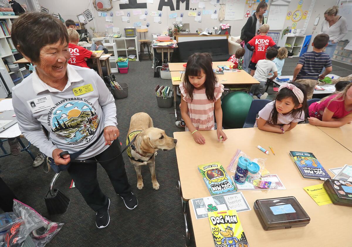Guide dog trainer Joyce Phelps introduces Moby to a few students at Hope View Elementary School.