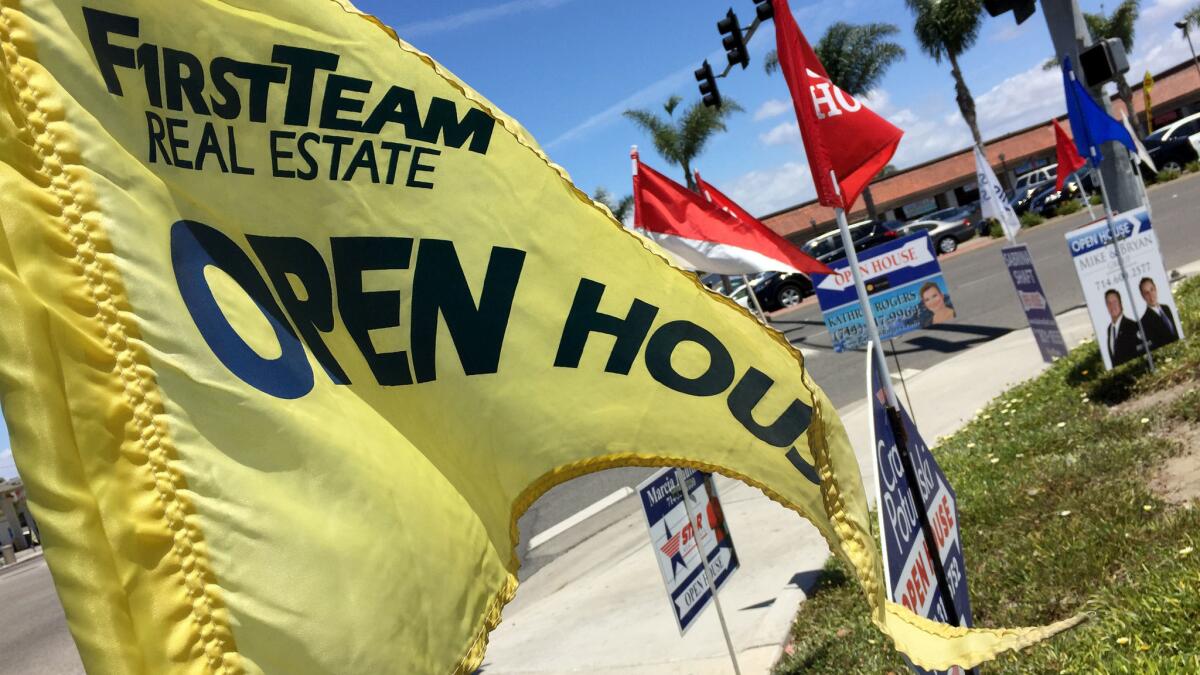 Open house signs are seen in Huntington Beach on May 21, 2016.