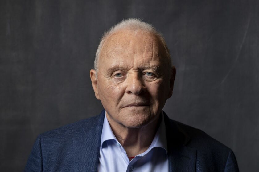 Anthony Hopkins posing in a blue shirt and jacket