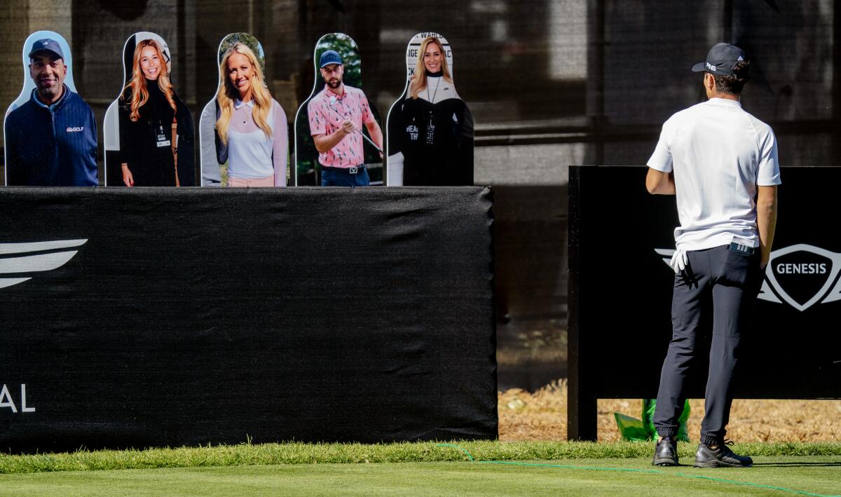 Joaquin Niemann gets a look at the cardboard cutout fans while waiting to hit his tee shot on the 14th hole on Feb. 19, 2021.