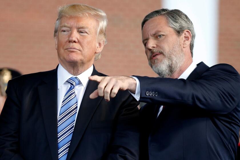 In this May 13, 2017 photo, President Donald Trump stands with Liberty University President Jerry Falwell Jr. in Lynchburg, Va. Falwell, in tweets and interviews in recent days, defended the presidentâs response to a white nationalist rally in Charlottesville, Virginia, that descended into deadly violence. A small group of Liberty University graduates are planning to return their diplomas to the evangelical Virginia school as a rebuke of Falwell Jr.âs latest showing of unwavering support for Donald Trump. (AP Photo/Steve Helber)