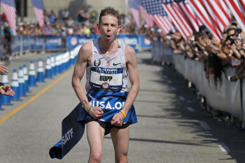 Galen Rupp of Portland, Ore., celebrates his victory after crossing the finish line in the U.S. Olympic men's marathon trial on Saturday in downtown Los Angeles.