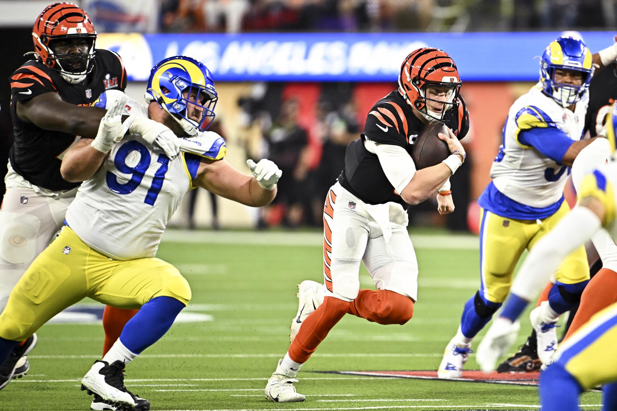 Cincinnati Bengals quarterback Joe Burrow carries the ball against the Rams in Super Bowl LVI at SoFi Stadium on Feb. 13.