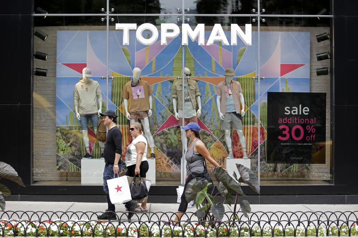 Shoppers walk along Michigan Avenue in Chicago on July 29.