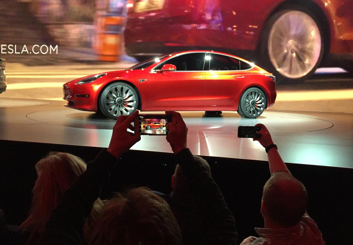 Tesla Motors unveils the new lower-priced Model 3 sedan at the Tesla Motors design studio in Hawthorne.