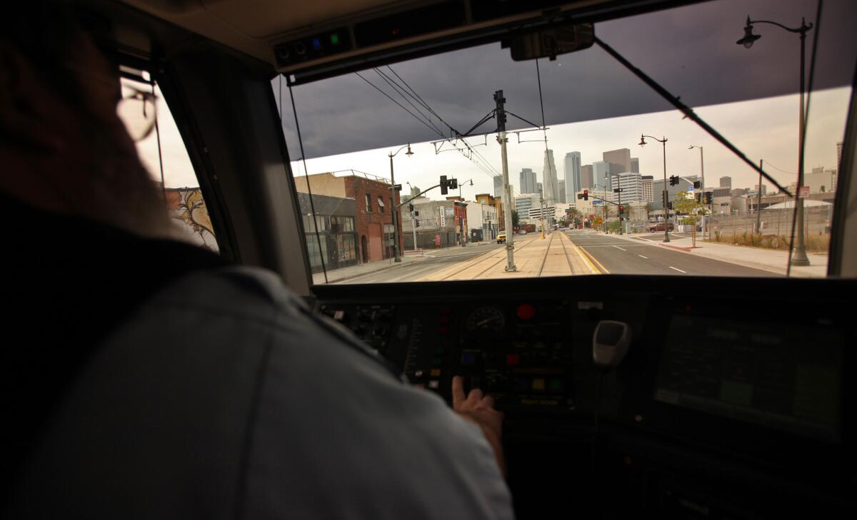 A Metro Gold Line operator guides a train heading west toward downtown Los Angeles.