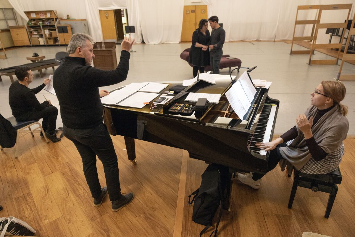 Conductor Bruce Stasyna, foreground left, and pianist Oxana Bulgakova.