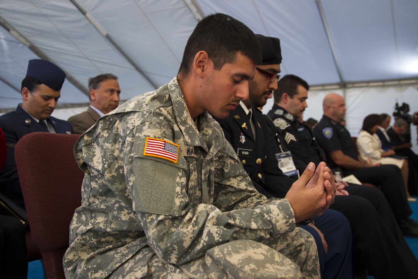 Army Pvt. Adeel Karim prays during a moment of silence for the San Bernardino shooting victims at the Jalsa Salana Convention at the Bait ul Hameed Mosque in Chino. Muslims from across the U.S. will confront the fears that non-Muslims have of Islam and delineate between true Islam and extremism.