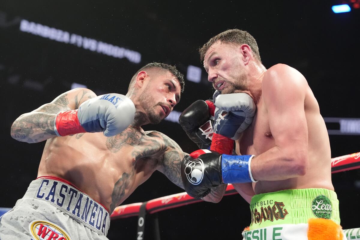 Arnold Barboza Jr., left, punches Sean McComb, right, during the fourth round of a super lightweight fight Saturday.