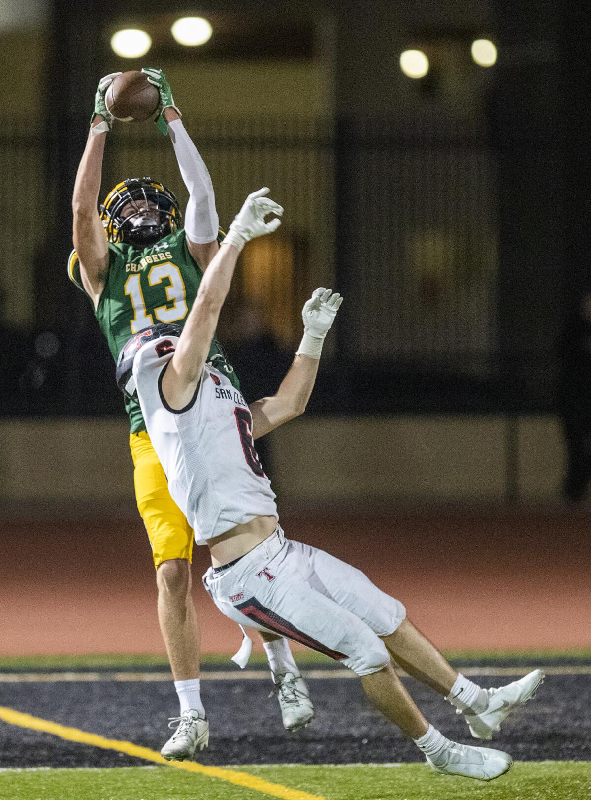 Edison's Tyler Hampton catches the ball over San Clemente's Blake Allen during a nonleague game on Friday.