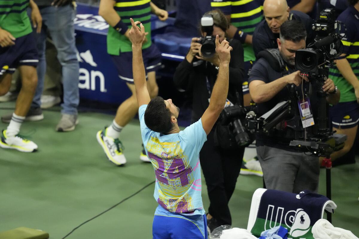 Novak Djokovic celebrates while wearing a shirt honoring Lakers great Kobe Bryant.
