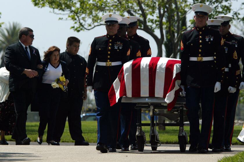 Simona Garibay follows the casket of her son, Cpl. Jose Garibay, who was killed in Iraq, at his funeral in 2003 with her other son, Gabriel, 16, at her left.