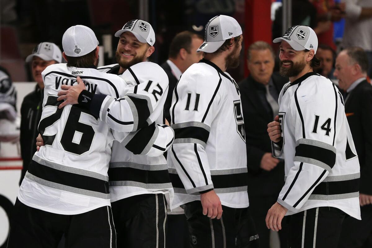 Slava Voynov (26) and Marian Gaborik (12) are among the Kings players celebrating after a 5-4 overtime victory over Chicago in Game 7 of the Western Conference finals.