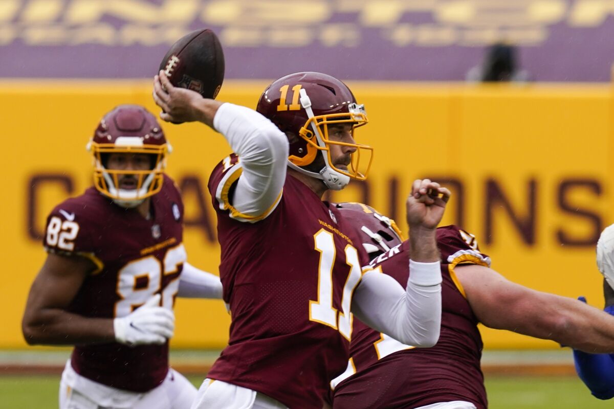 Washington quarterback Alex Smith throws during the first half of Sunday's loss to the Rams.