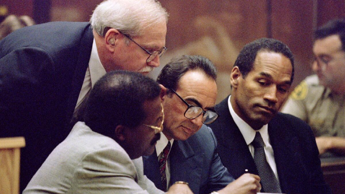 Johnnie Cochran, from left, Gerald Uelmen, Robert Shapiro and defendant O.J. Simpson confer during the trial. (Associated Press)