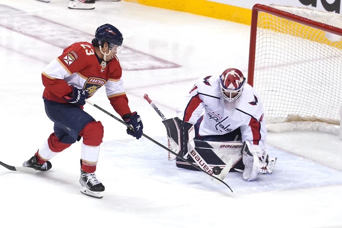 Washington Capitals goaltender Vitek Vanecek stops a shot on goal by Florida Panthers center Carter Verhaeghe.