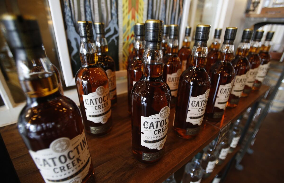FILE - In this June 20, 2018 file photo, Catoctin Creek Distillery whiskey is on display in a tasting room in Purcellville, Va. American whiskey producers raised a glass to celebrate a trans-Atlantic agreement to end retaliatory tariffs that sank their sales in Europe. Now comes the challenge of rebuilding brands that were stymied in those ultra-competitive markets during the lengthy trade dispute. (AP Photo/Steve Helber, File)