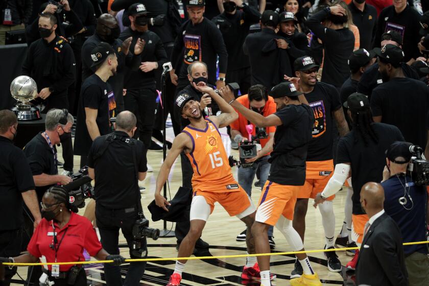 Cameron Payne dances with teammates after the Suns beat the Clippers to win the Western Conference finals on June 30, 2021.
