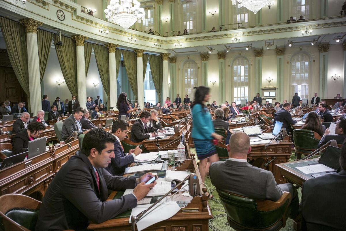 Assembly members work on the final bills of the year on Friday.