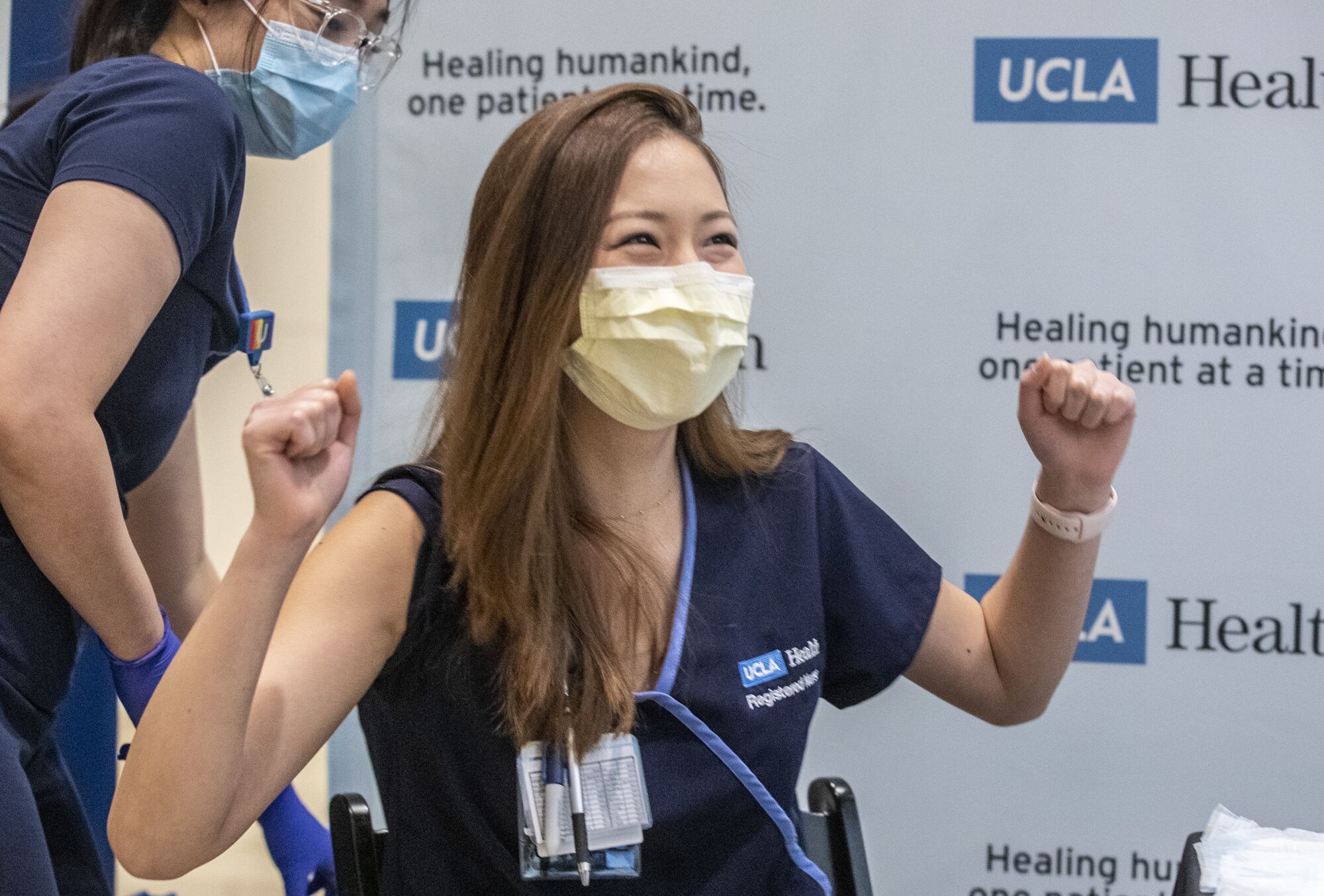 Nurse Nicole Chang celebrates after receiving one of the first doses of COVID-19 vaccine at Ronald Reagan UCLA Medical Center