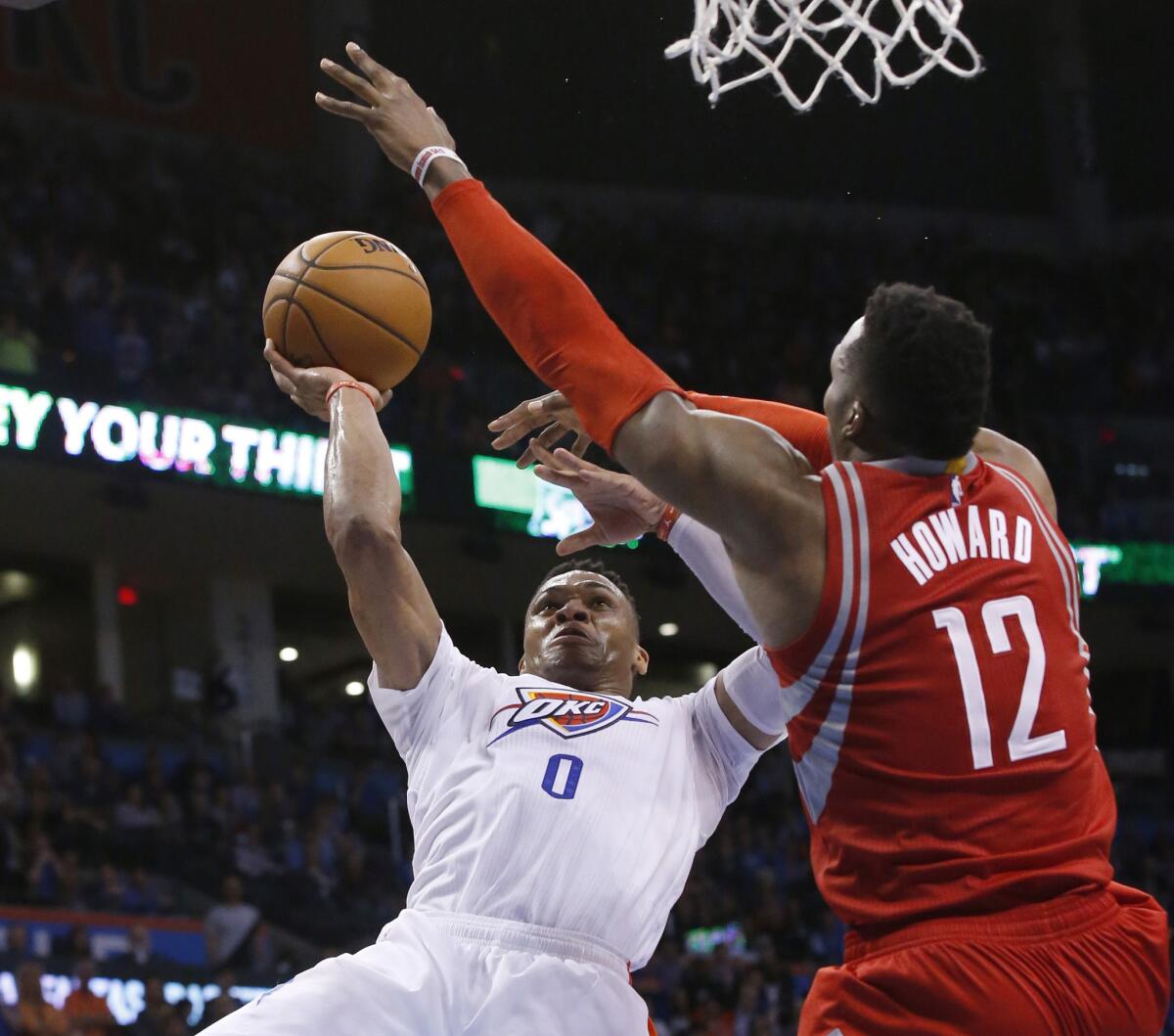 Thunder guard Russell Westbrook (0) shoots over Rockets center Dwight Howard (12) during the fourth quarter of a game on March 22.