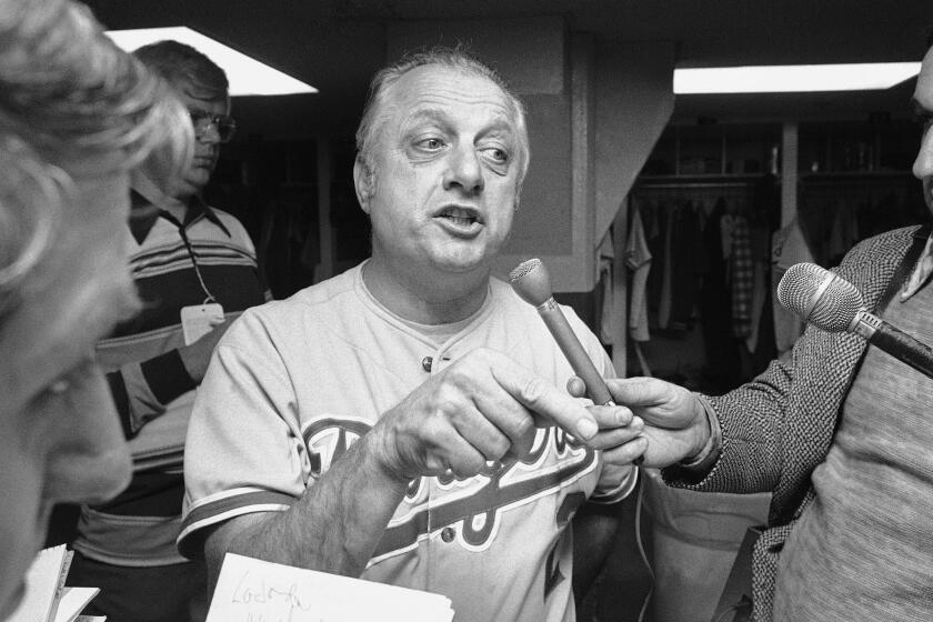 Dodgers Manager Tom Lasorda talks to reporters after his team lost the first game of the World Series, 4-3.