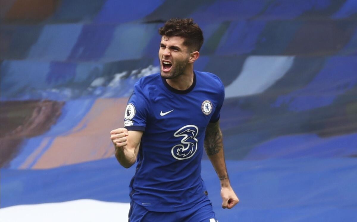 Chelsea's Christian Pulisic celebrates scoring their side's first goal during the English Premier League soccer match between Chelsea and West Bromwich Albion at Stamford Bridge stadium in London, England, Saturday, April 3, 2021.(Clive Rose/Pool via AP)