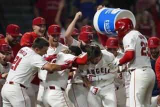 Los Angeles Angels' Mickey Moniak (16) celebrates with teammates after hitting a walk-off home run.