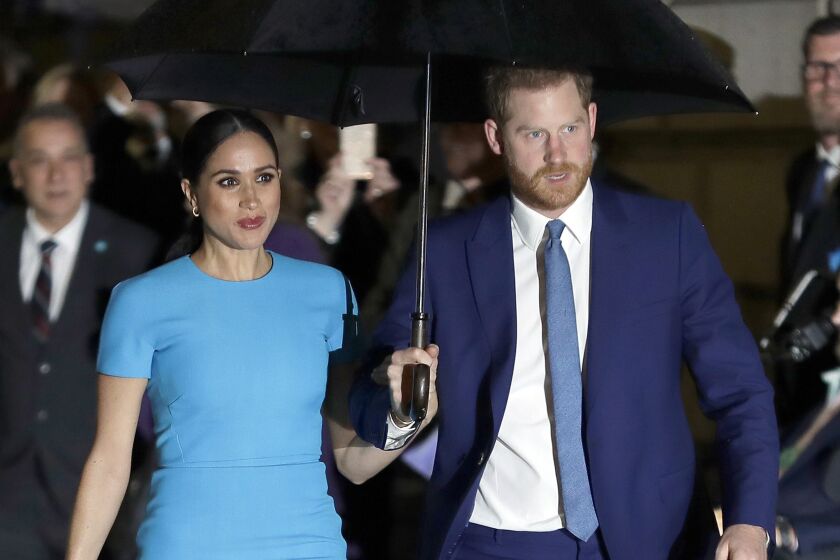 FILE - In this March 5, 2020 file photo, Britain's Prince Harry and Meghan, the Duke and Duchess of Sussex arrive at the annual Endeavour Fund Awards in London. Britain’s Prince Harry says it took him many years and the experience of living with his wife, the former Meghan Markle, to understand how his privileged upbringing shielded him from the reality of unconscious bias. (AP Photo/Kirsty Wigglesworth, File)