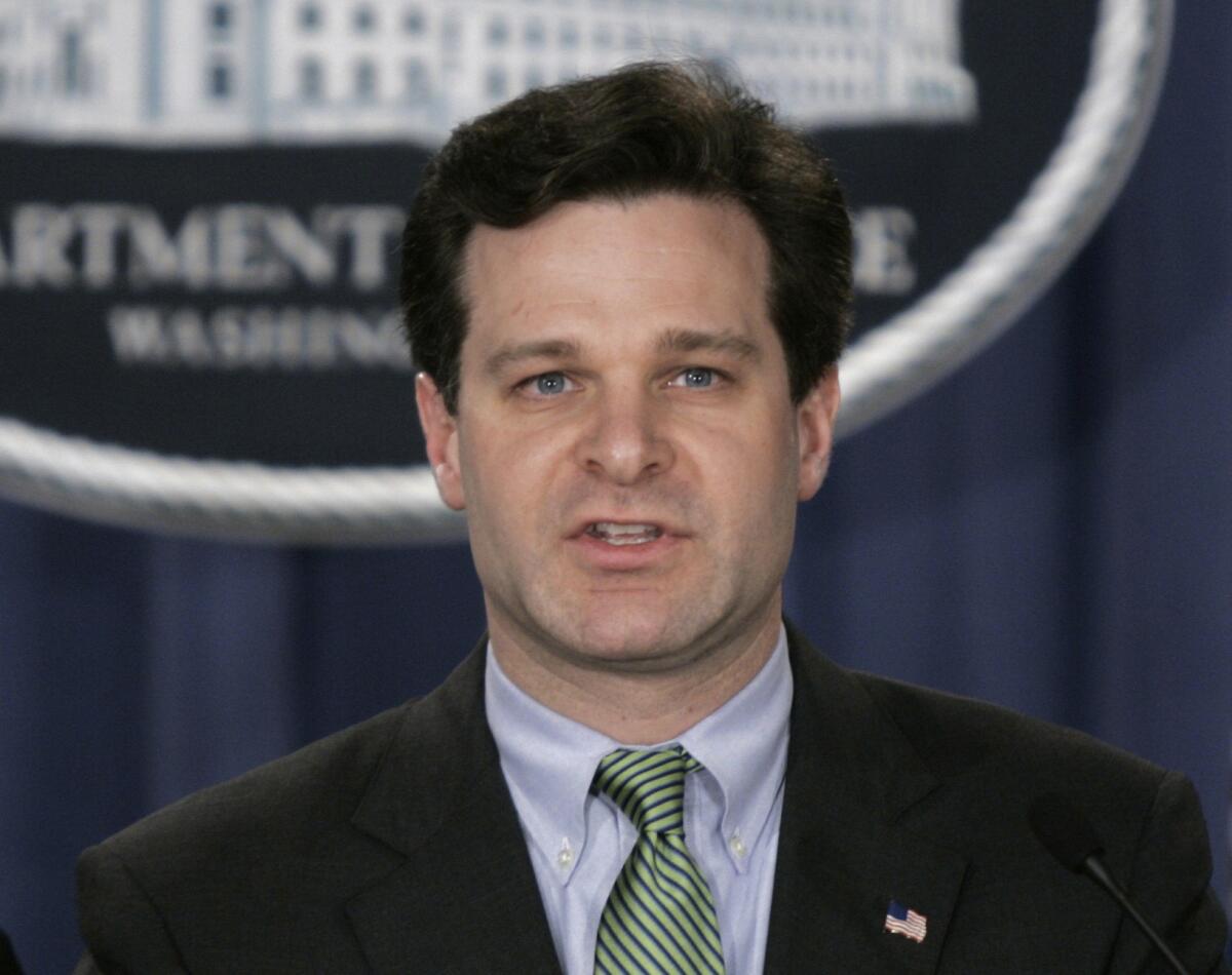 In this Jan. 12, 2005 file photo, then-Assistant Attorney General Christopher Wray speaks at a press conference at the Justice Dept. in Washington.