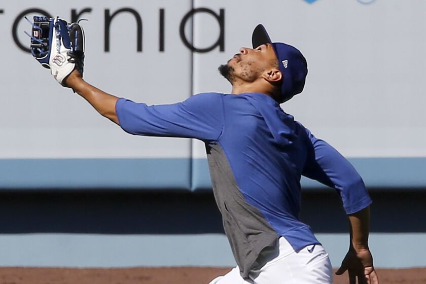 LOS ANGELES, CALIF. - JULY 3, 2020. Dodgers right fielder Mookie Betts catches fly balls.