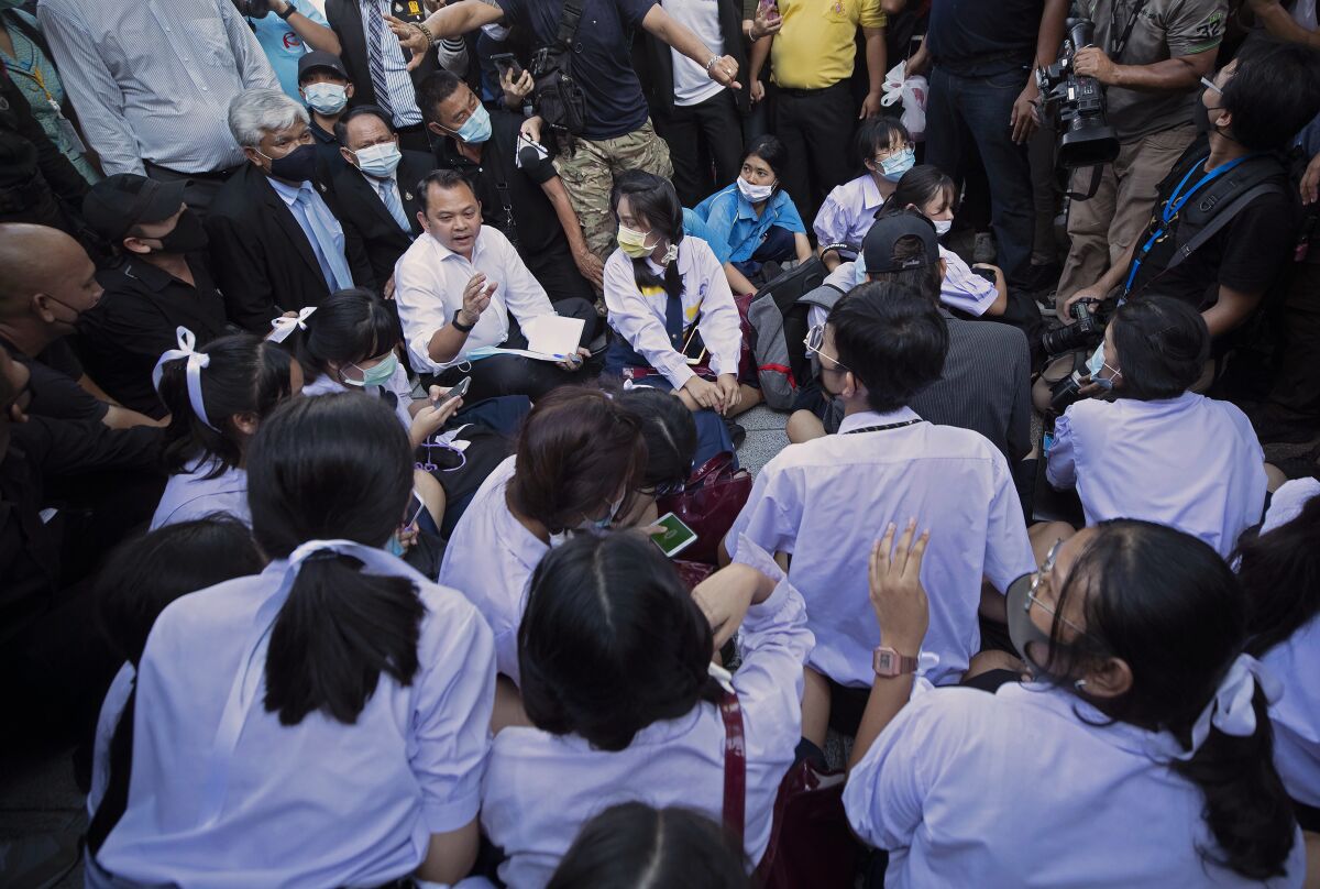 In this Aug. 19, 2020, file photo, Education Minister Nataphol Teepsuwan, center left in white shirt, talks to pro-democracy self-named "Bad Students" during a protest rally in front of Education Ministry in Bangkok, Thailand. The Bad Student group has spoken out about issues including the physical abuse of students, which has gotten more public attention in the past two weeks as video emerged of young children including kindergarten students being mistreated by teachers at a private school outside Bangkok. (AP Photo/Sakchai Lalit, File)