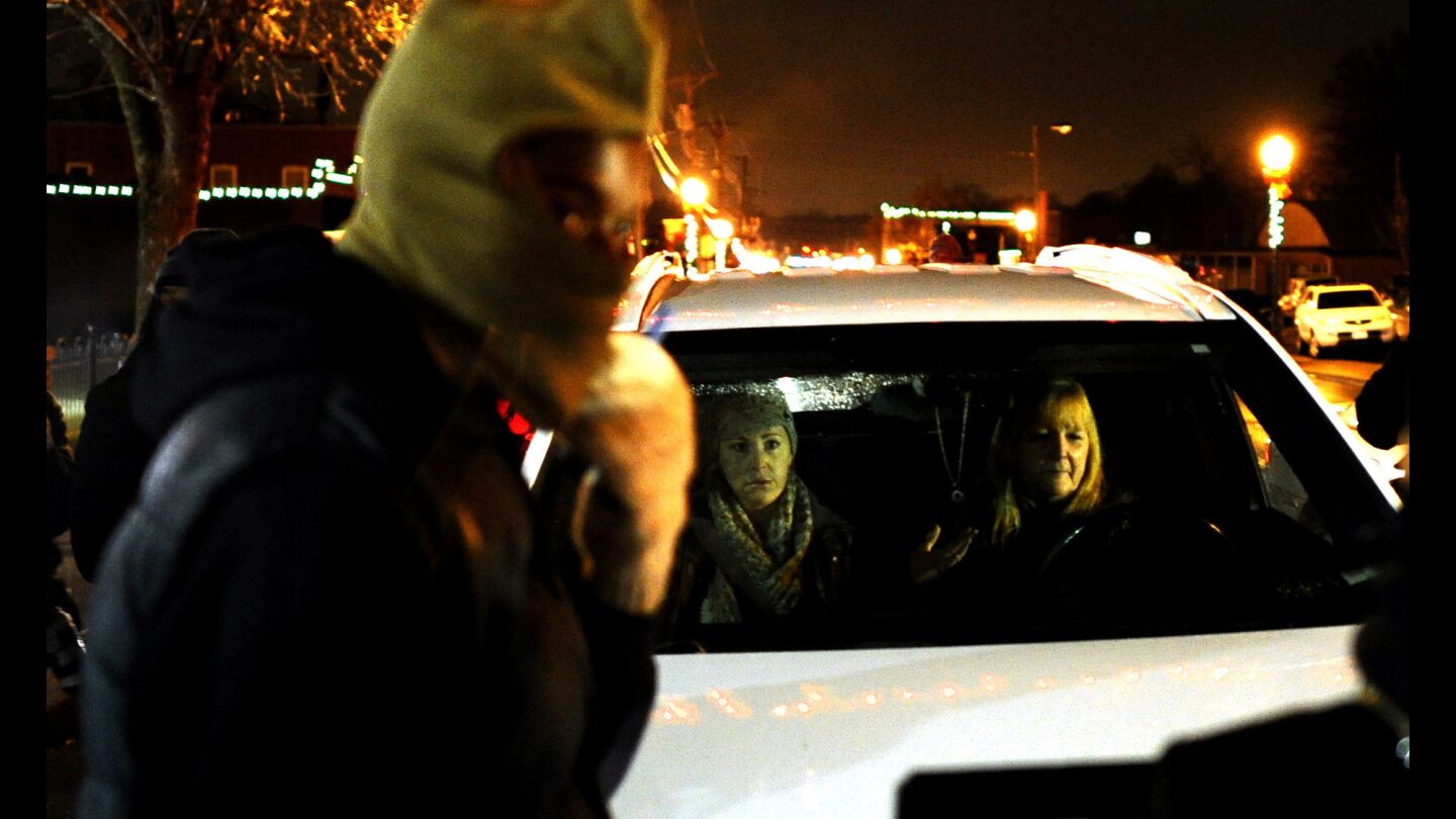 Protesters block two women in a vehicle from passing outside the Ferguson police station during a demonstration in Missouri on Nov. 21.