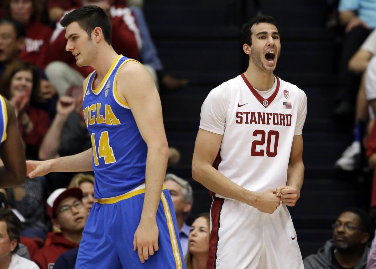 Stanford center Josh Sharma (20) reacts after being fouled while driving to the basket next to UCLA forward Gyorgy Goloman (14) during the first half of a game on Feb. 27.