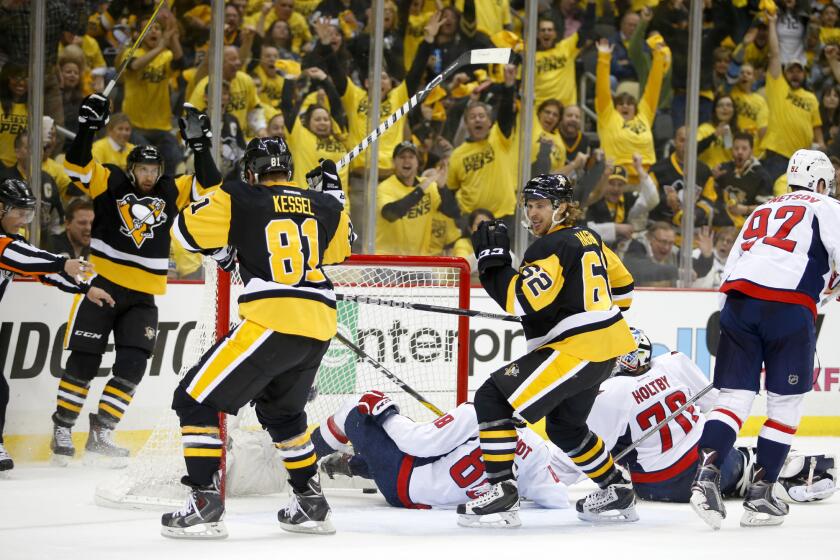 Penguins' Carl Hagelin (62) celebrates his second-period goal against Capitals goalie Braden Holtby (70) during Game 3.