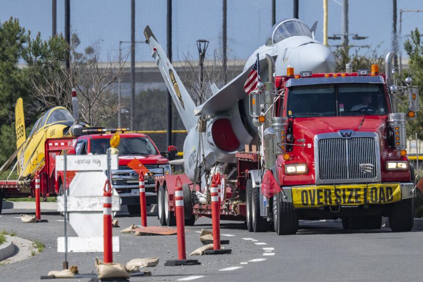 Three aircraft on flatbed trucks make their way through the Great Park in Irvine after departing MCAS Miramar in San Diego to their new home at the Great Park in Irvine on Tuesday morning, March 5, 2024. The three aircraft moved on Tuesday included: a Beechcraft T-34 Mentor; a Boeing F/A-18 Hornet and a Chinese-built MiG 15. They will be a part of over 40 aircraft on display at the Flying Leathernecks Aviation Museum at the Great Park. (Photo by Mark Rightmire, Orange County Register/SCNG)