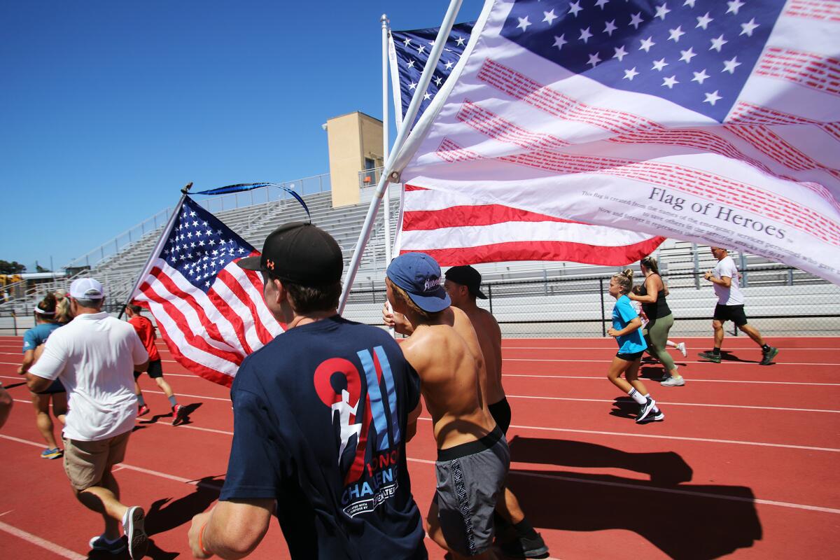 Participants start the 911 Honor Challenge at Sheue Field at Huntington Beach High School Sunday.