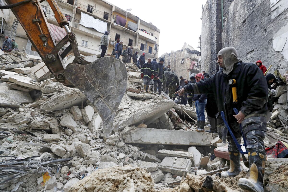 People search the wreckage of collapsed buildings 