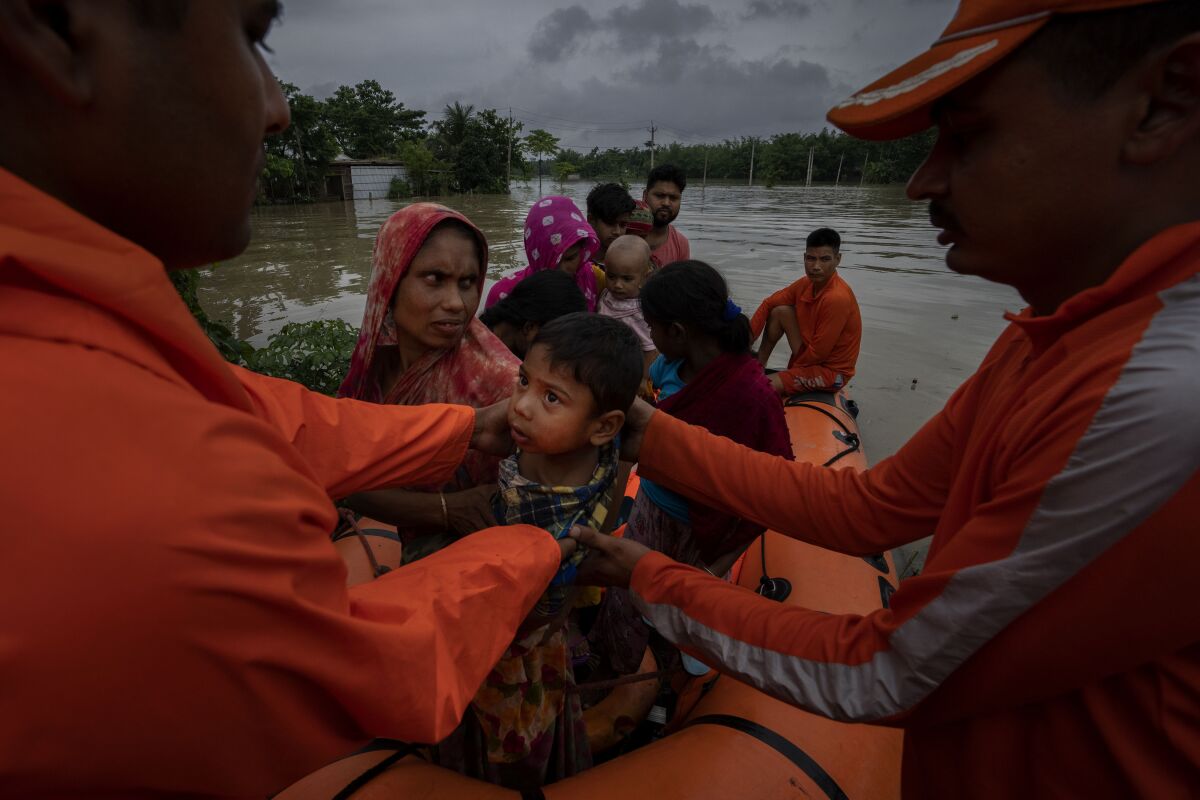 National Disaster Response Force (NDRF) personnel rescue flood-affected villagers in Korora village, west of Gauhati, India, Friday, June 17, 2022. (AP Photo/Anupam Nath)