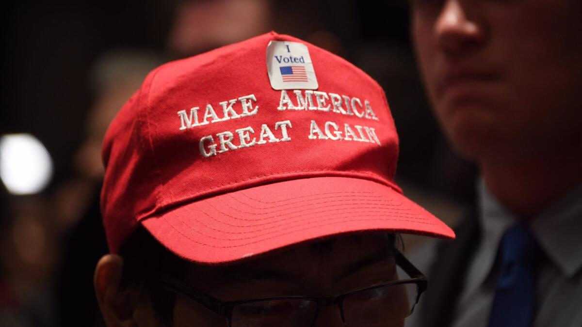 A supporter of Republican senatorial candidate Roy Moore wears President Trump's signature baseball cap in Montgomery, Ala., on Tuesday.