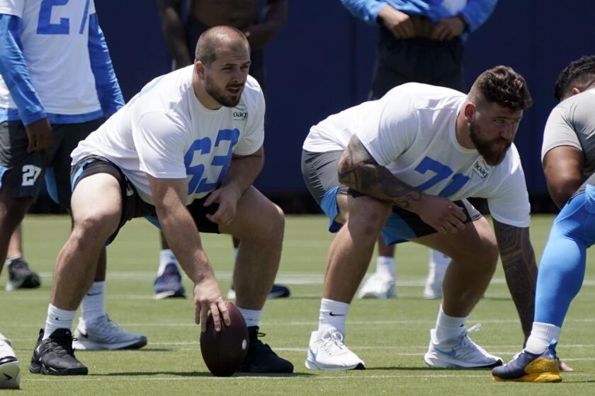 Chargers center Corey Linsley and guard Matt Feiler line up during practice in Costa Mesa.