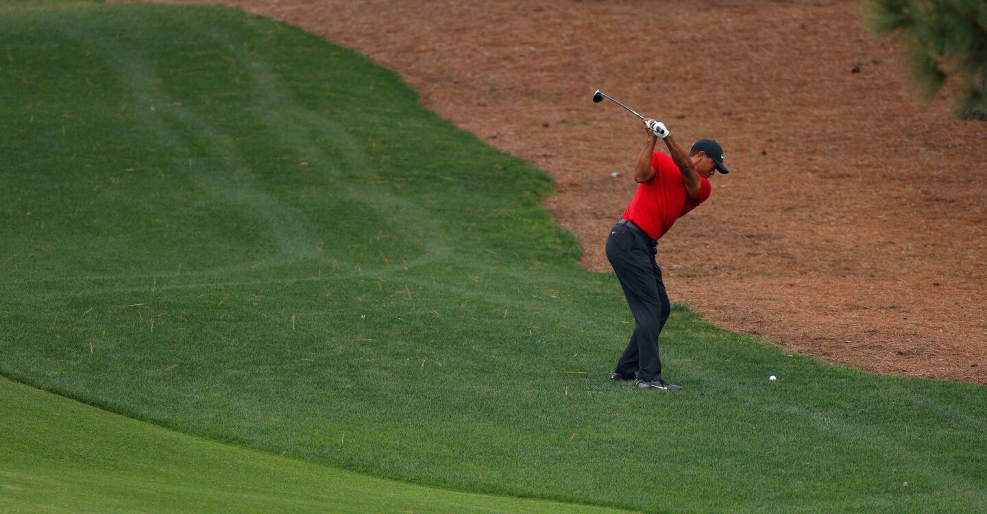 Tiger Woods hits from off the fairway on the eighth hole during the final round of the 2019 Masters tournament on Sunday.