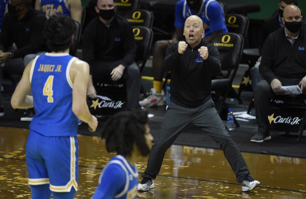 UCLA coach Mick Cronin discusses rebounding technique with guard Jaime Jaquez Jr.