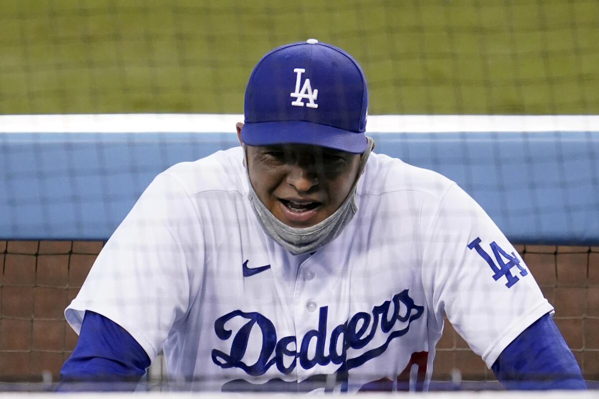 Dodgers manager Dave Roberts smiles in the dugout during Game 1 on Wednesday.