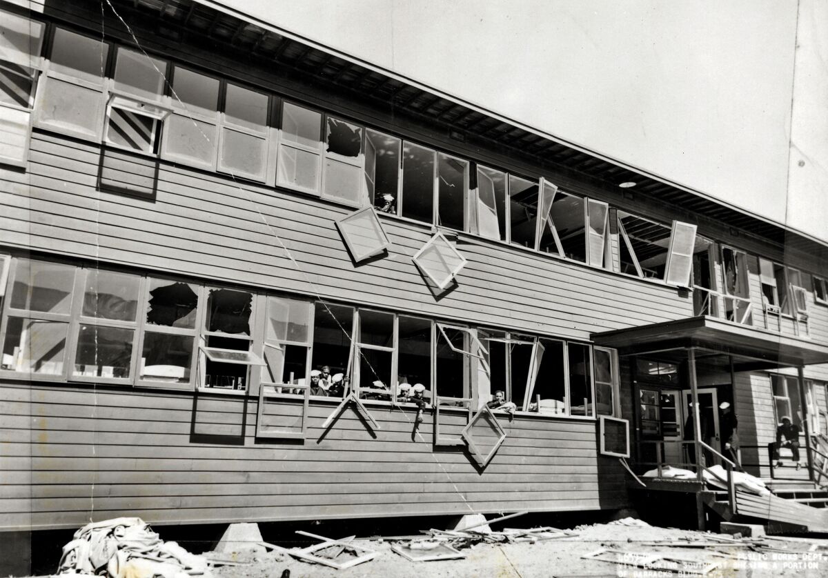 Historical photo taken after the blast of some 5000 tons of TNT that rocked the U.S. Navy's Port Chicago on July 17, 1944, kiling 320 people. This is an Exterior view of barracks with sailors visible in windows.