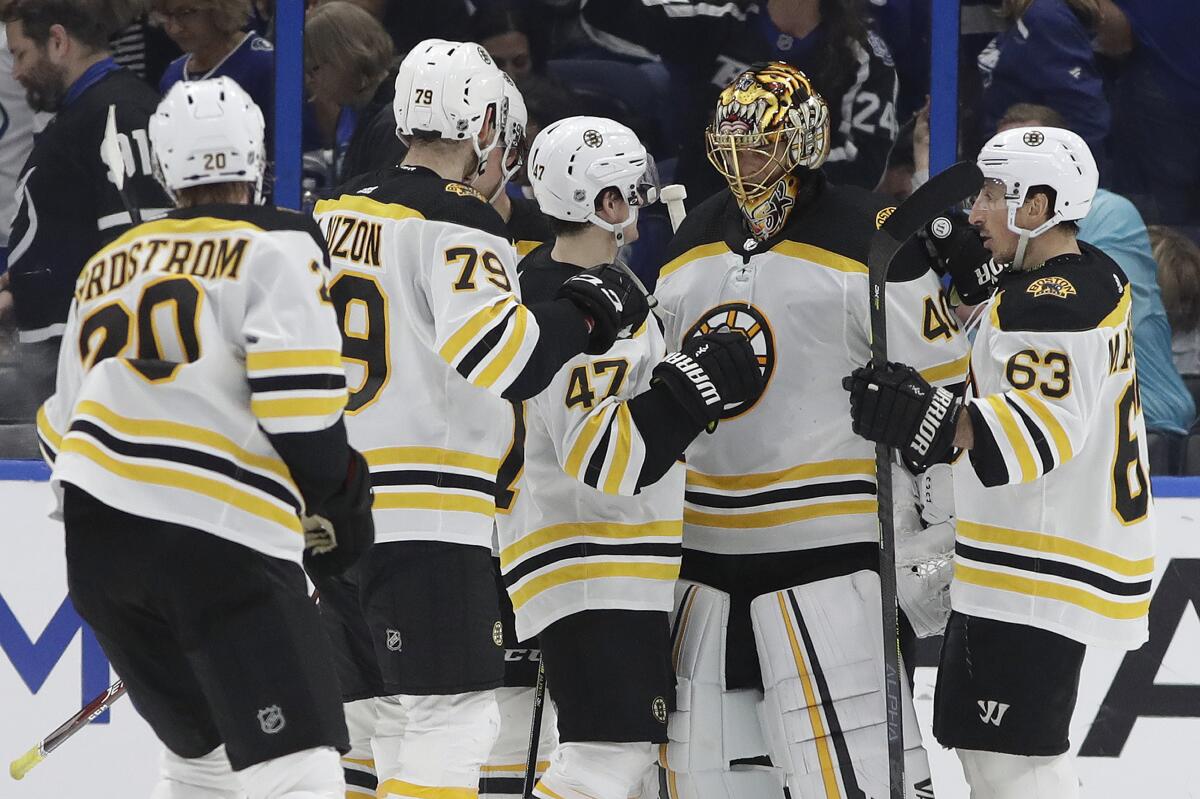 Boston Bruins players celebrate after a win.