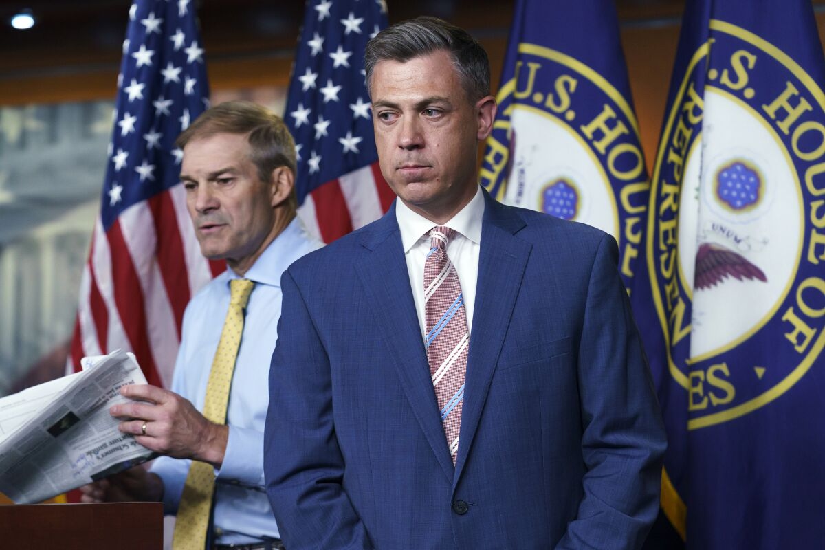 FILE - Rep. Jim Banks, R-Ind., right, and Rep. Jim Jordan, R-Ohio, left, exchange places at the podium during a news conference at the Capitol in Washington, Wednesday, July 21, 2021. Banks, an Indiana congressman regained control of his office Twitter account on Friday, Nov. 5, 2021, after he deleted a post about a transgender Biden administration official that the social media company found violated its rules. (AP Photo/J. Scott Applewhite, File)