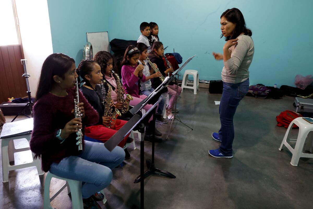 Guadalupe Ramirez, right, gives music lessons at the Casa de la Cultura in Tlaxiaco.