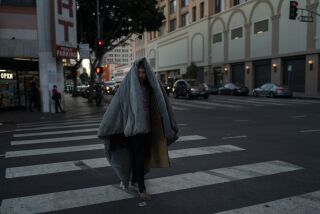 A mentally ill homeless man walks across the street with a thick blanket over him in Los Angeles, Friday, April 15, 2022. Drug abuse can be a cause or symptom of homelessness. Both can also intersect with mental illness. A 2019 report by the Los Angeles Homeless Services Authority found about a quarter of all homeless adults in Los Angeles County had mental illnesses and 14% had a substance use disorder. That analysis only counted people who had a permanent or long-term severe condition. Taking a broader interpretation of the same data, the Los Angeles Times found about 51% had mental illnesses and 46% had substance use disorders. (AP Photo/Jae C. Hong)