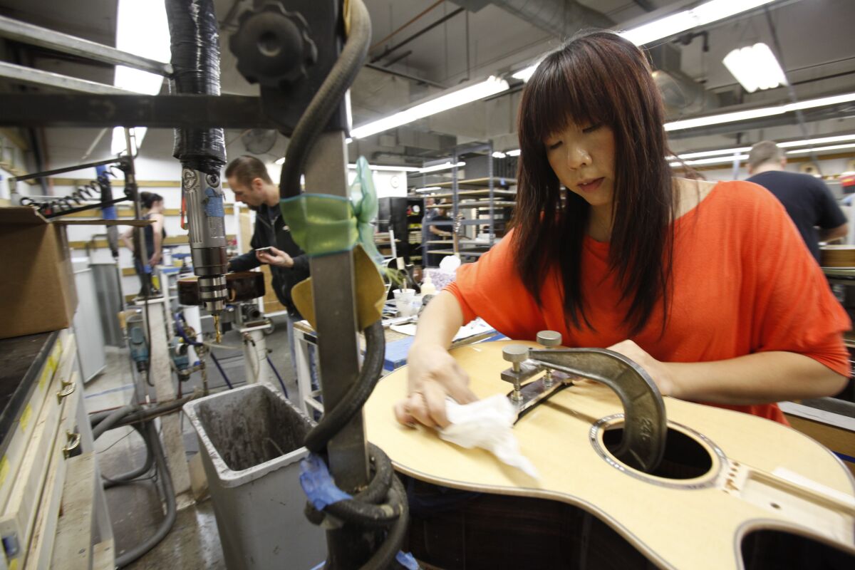 Taylor Guitars employees create the company's musical instruments at their El Cajon facility in 2012.